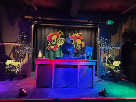 DJ performing under Savoy Tivoli signage with colored stage lights in San Francisco — salsa venue in San Francisco
