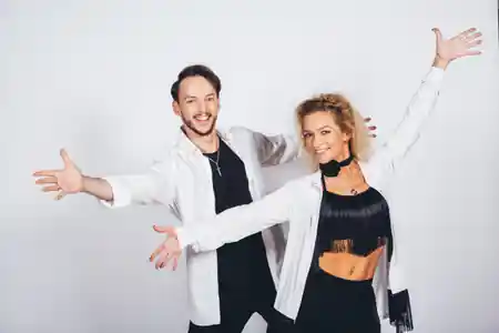 Latin dance instructors in dance attire welcoming guests to Dos Mundos party at Atlas Tower Warsaw — bachata, salsa, kizomba venue in Warsaw