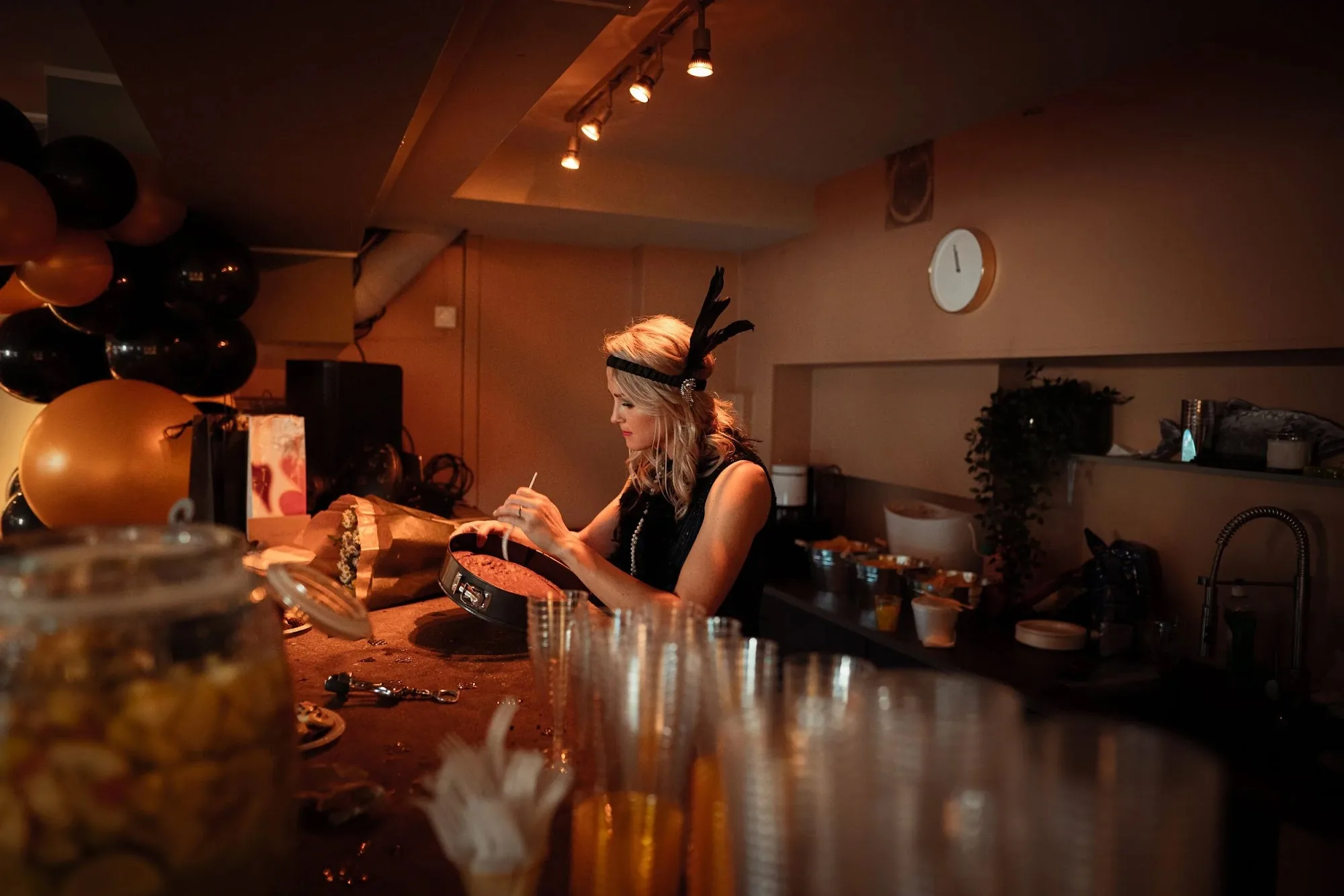 Påfuglen Oslo — bar area at night with warm amber lighting and bartender in costume