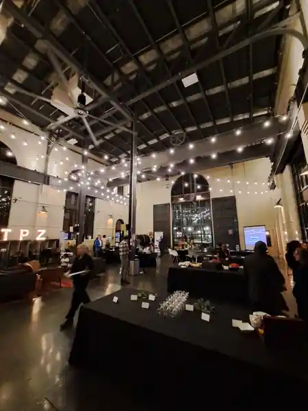 Evening event at The Substation Boston with string lights, crowd and TPZ neon — large industrial dance hall atmosphere — salsa venue in Boston