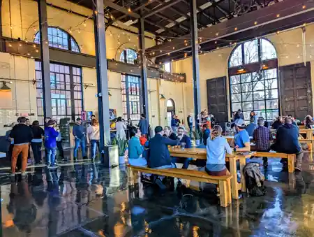 Crowd gathered under string lights at The Substation Boston, social event in the brick-and-arched-window venue — salsa venue in Boston