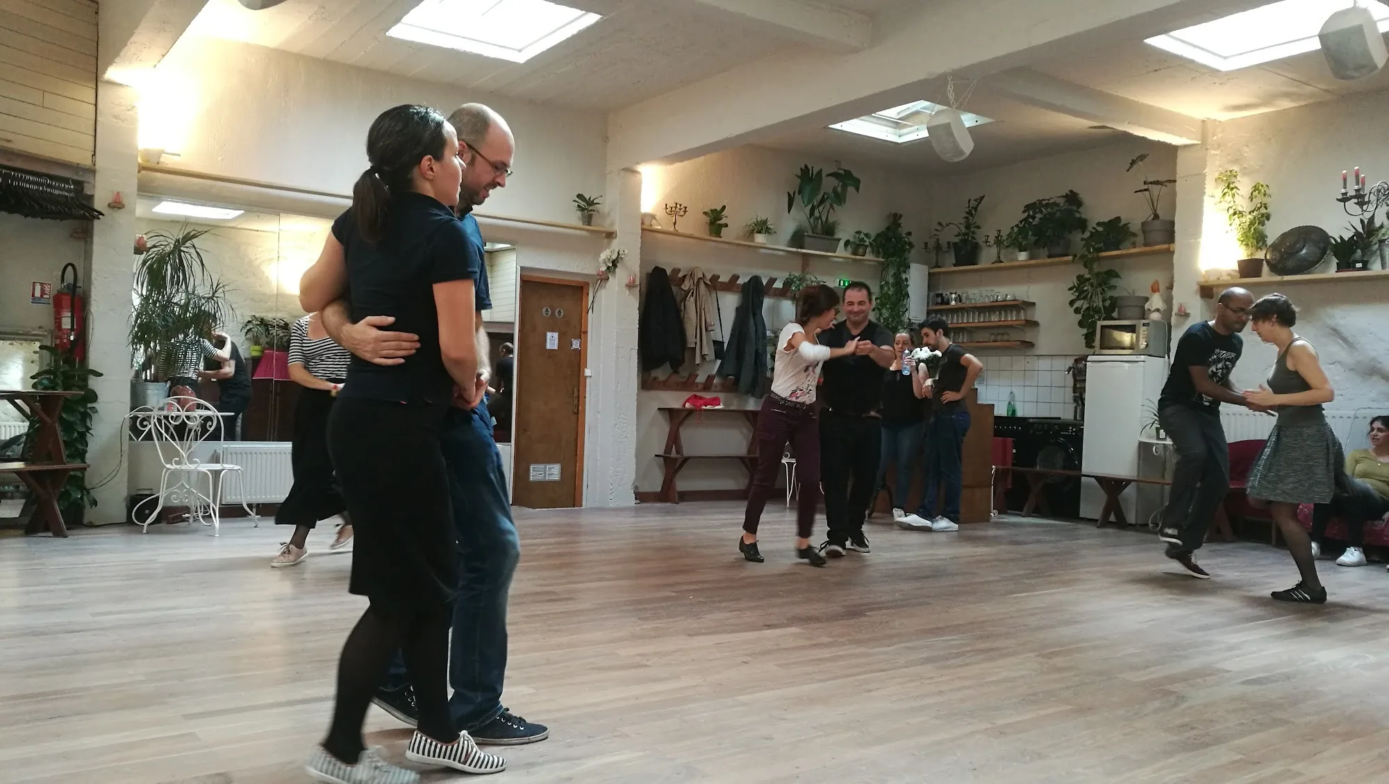 Multiple couples social dancing partner dances in the Loft Lechapelais dance space