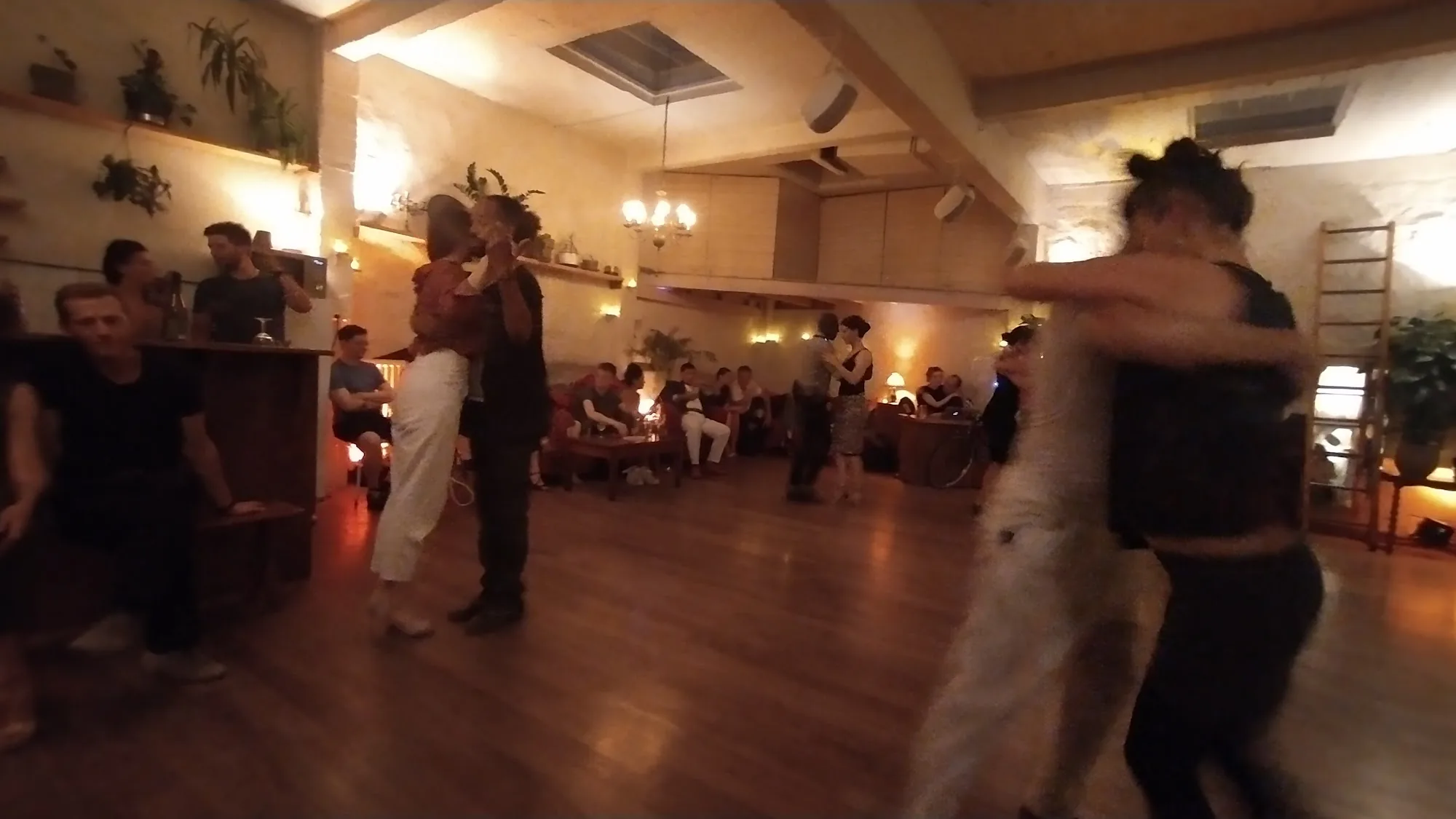 Live social dance event at Loft Lechapelais with couples dancing and audience seated around the dance floor