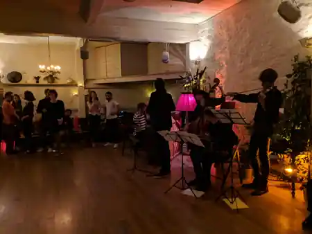 String quartet performing at Loft Lechapelais with audience watching in the candlelit space — zouk venue in Paris
