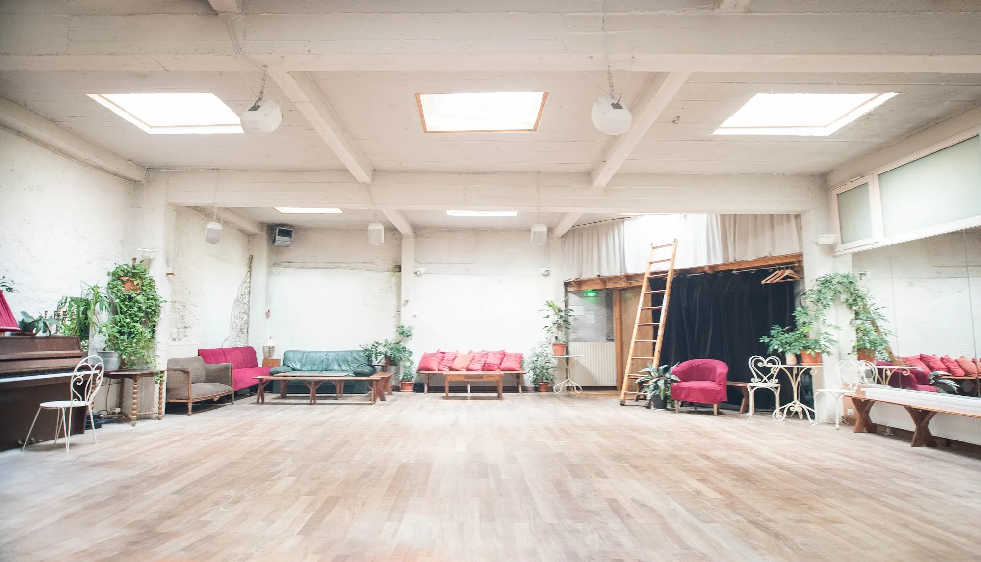 Empty Loft Lechapelais dance hall in daylight showing the large wooden floor and cosy seating