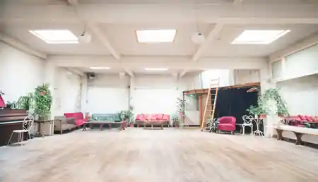 Empty Loft Lechapelais dance hall in daylight showing the large wooden floor and cosy seating — zouk venue in Paris