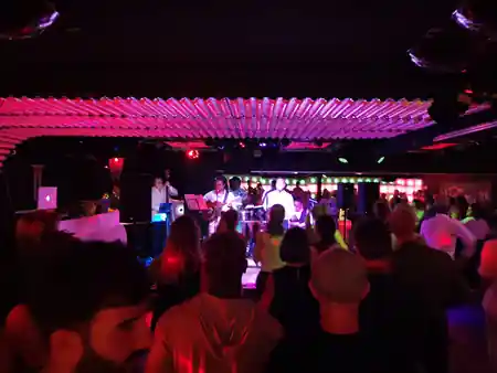 Live Latin band on stage with packed dance floor crowd at Sabor Latino Winterthur — salsa, bachata, kizomba venue in Winterthur