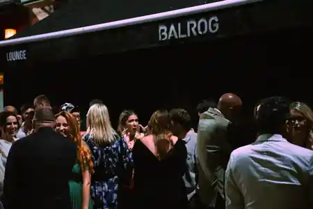 Large crowd outside Balrog Bar lounge with branded awning at night, Cannes — salsa, bachata venue in Cannes