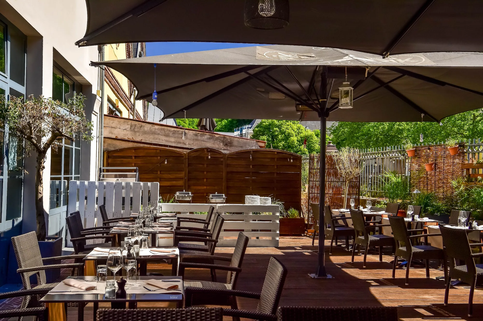 Terrace with outdoor seating and bar at IKKI Rives de Clausen Luxembourg City