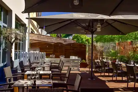 Terrace with outdoor seating and bar at IKKI Rives de Clausen Luxembourg City — bachata venue in Luxembourg City