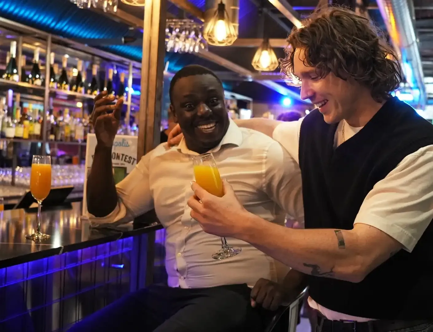Patrons enjoying drinks at the illuminated bar inside Metropolis Vauxhall in London