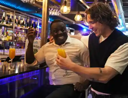 Patrons enjoying drinks at the illuminated bar inside Metropolis Vauxhall in London — bachata venue in London