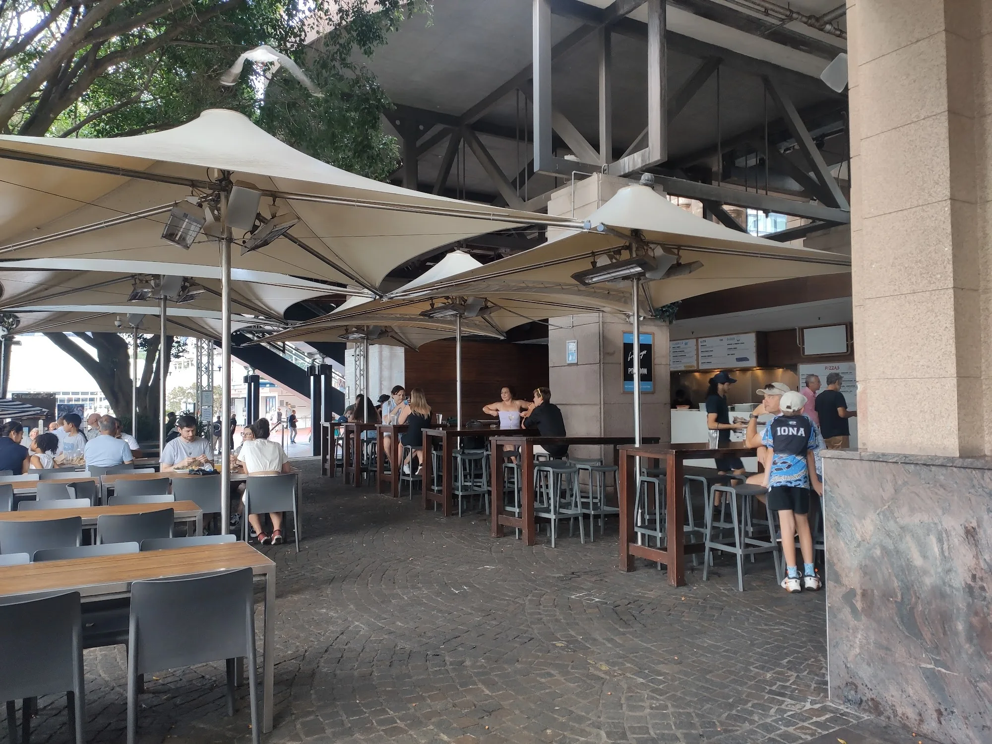 Pontoon Bar covered terrace and bar counter with patrons in Darling Harbour Sydney