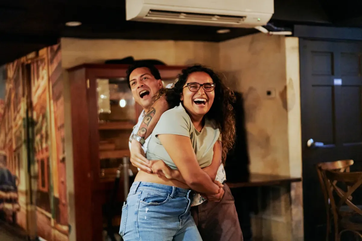 Couple laughing and embracing inside Casta’s Rum Bar in Washington DC during salsa night