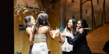 Group of women cheering with cocktails at Casta’s Rum Bar in Washington DC — salsa venue in Washington, D.C.