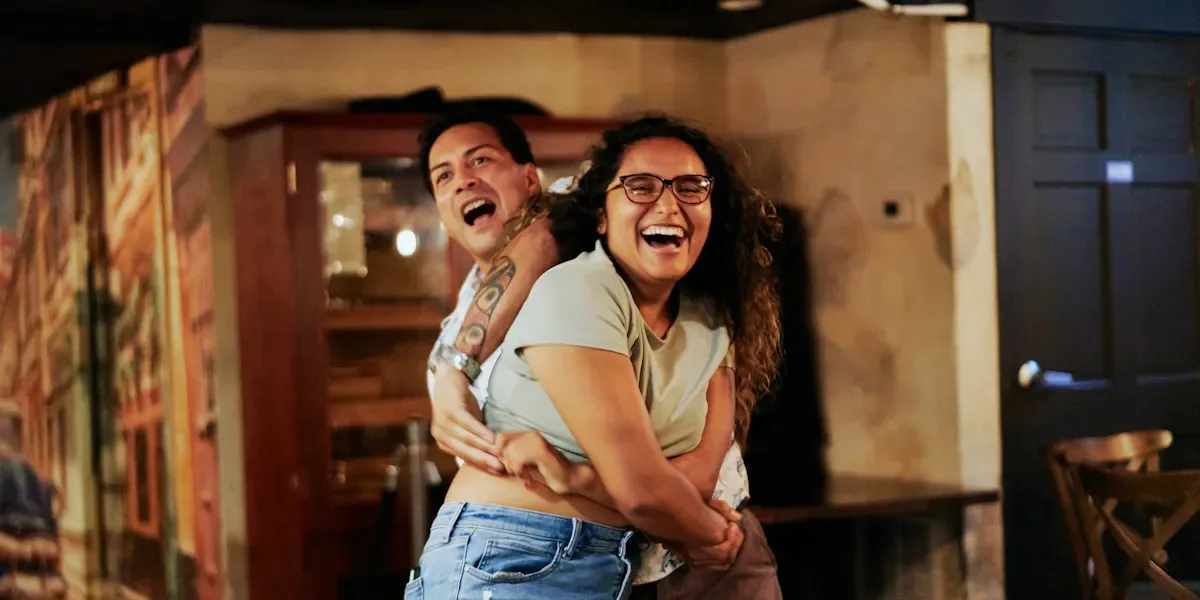 A joyful couple dancing salsa together at Casta's Rum Bar in Washington, D.C., laughing as they move on the dance floor