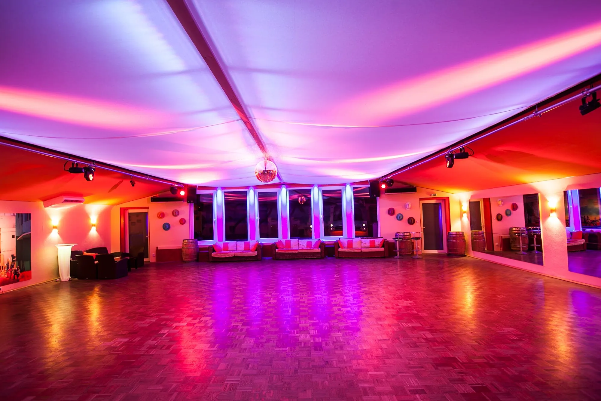 Empty dance floor with pink and purple stage lighting at Salsa del Alma Hannover