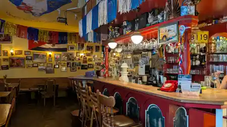 Martinez bar counter in Dresden with Cuban-themed colorful decor and vintage bottles — salsa venue in Dresden