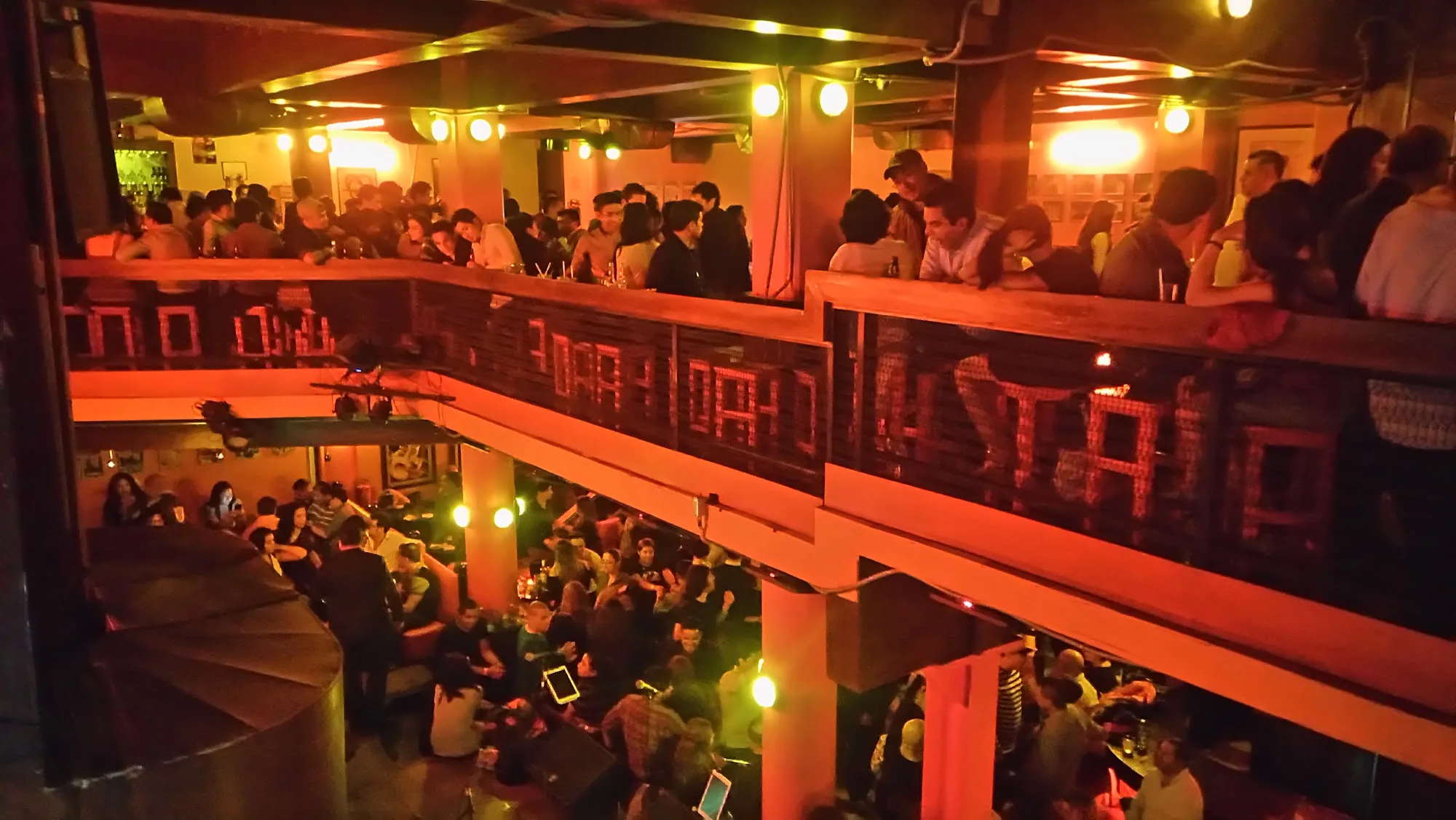 Packed two-level dance venue crowd at Mama Rumba in Madrid during a live event