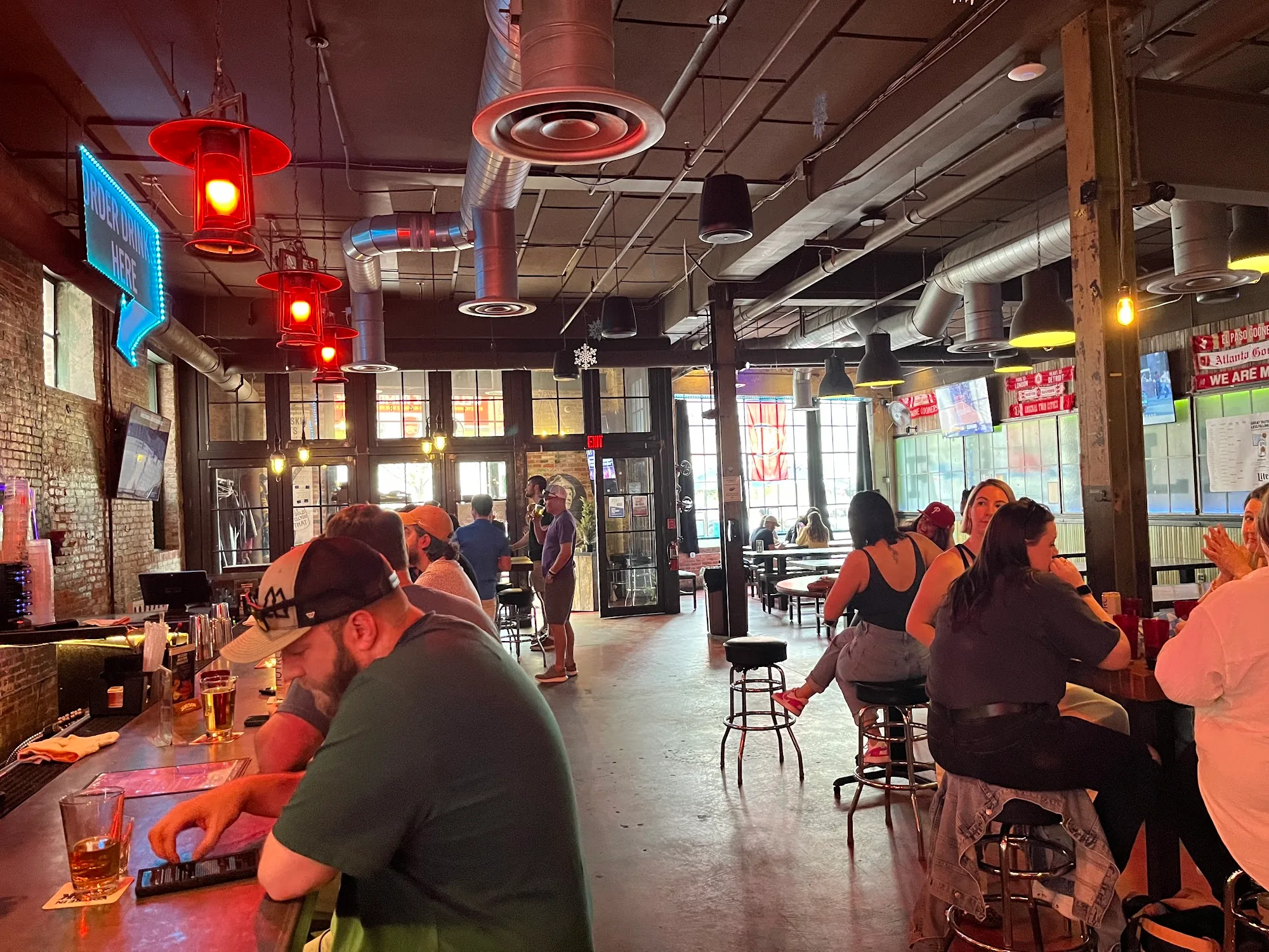Lively bar and lounge crowd at Franklin Hall in Washington, D.C. with industrial pendant lighting