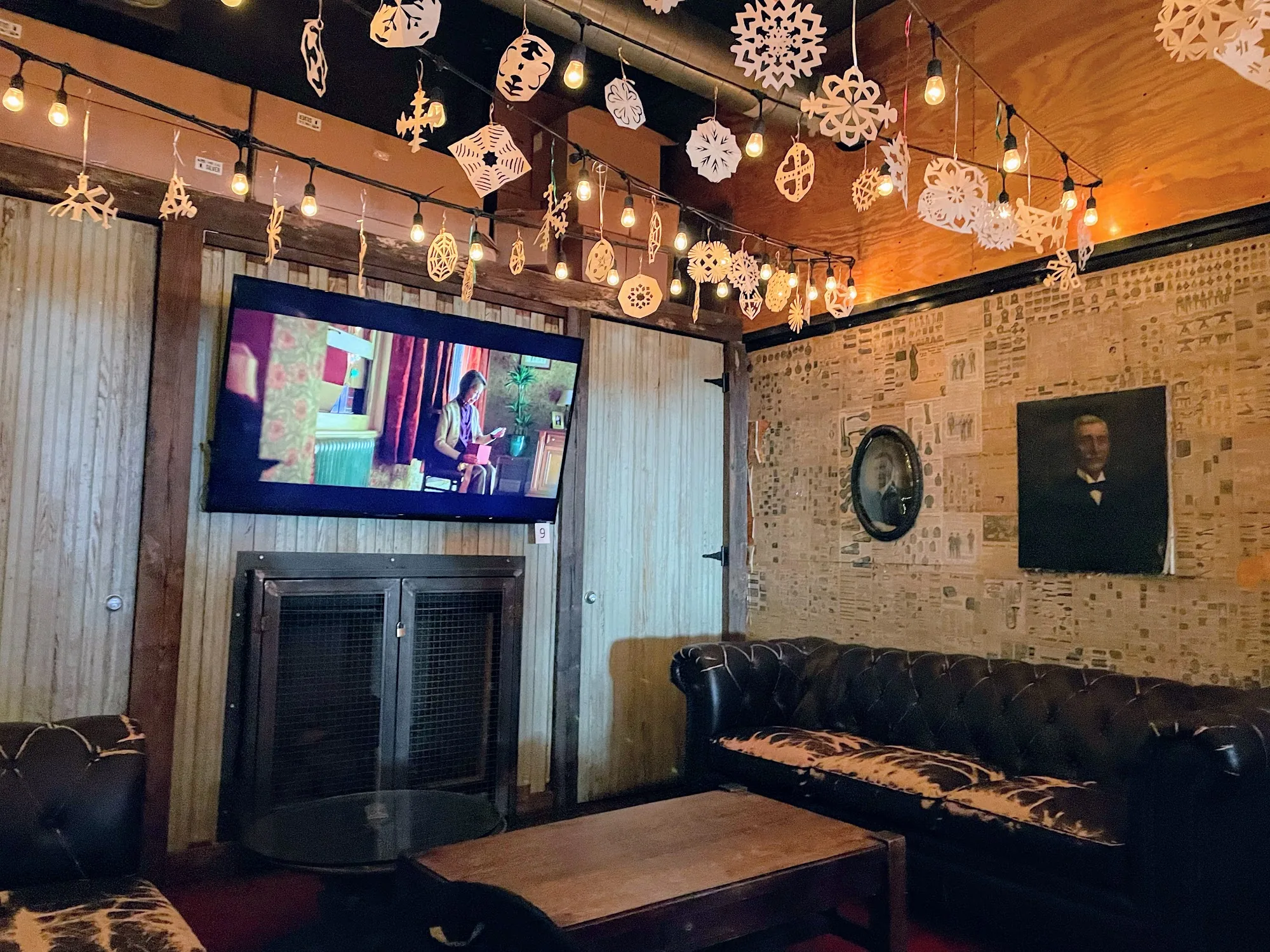 Cozy lounge corner at Franklin Hall in Washington, D.C. with leather couch and string lights