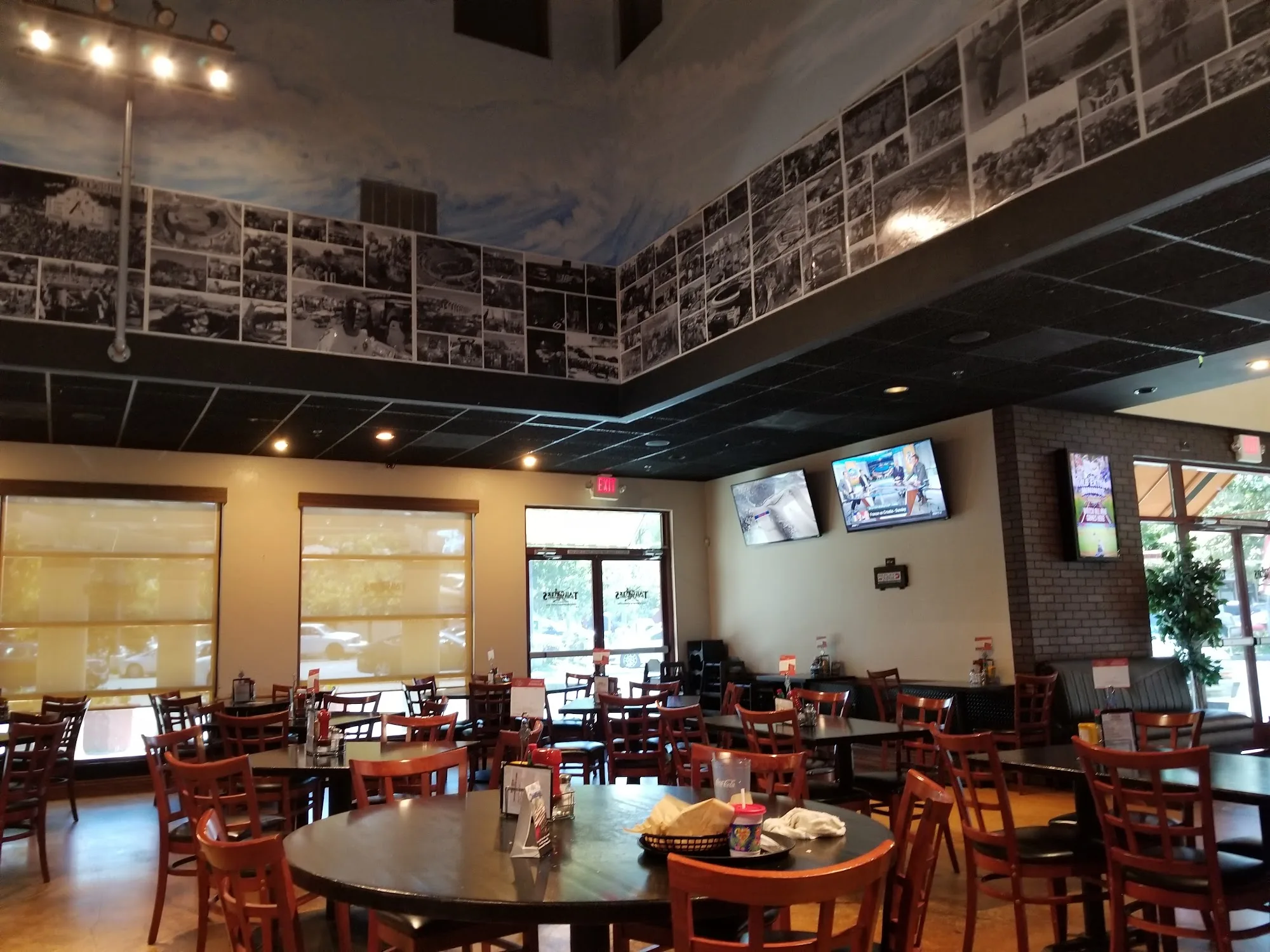 Dining room interior with tables and photo-mural walls at Tailgaters Sports Bar, Antioch