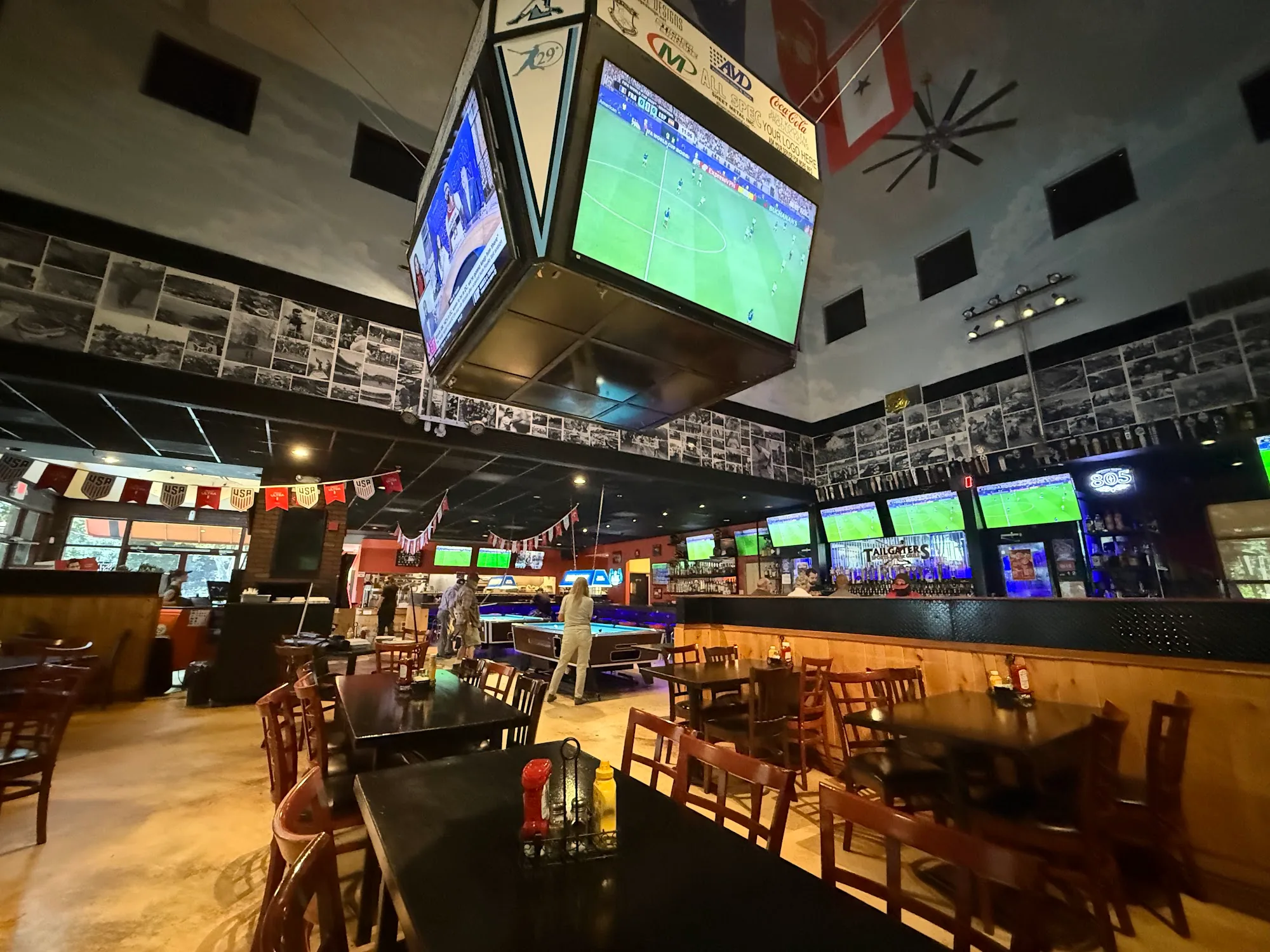 Sports bar interior with big screens, bar and pool table at Tailgaters in Antioch