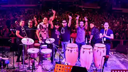 Live Latin band performing on stage at Gonzalez y Gonzalez in New York with percussion instruments and an energetic crowd — salsa, bachata venue in New York