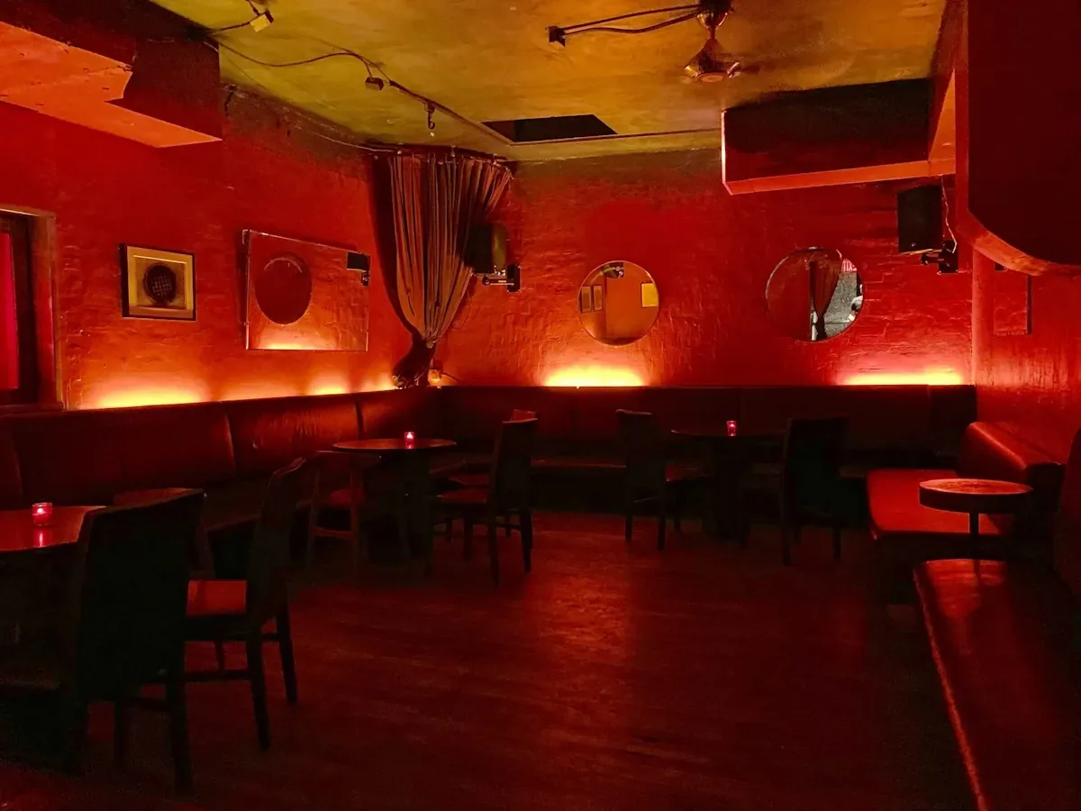 Red-lit lounge seating and signature interior at Solas Bar in New York's East Village