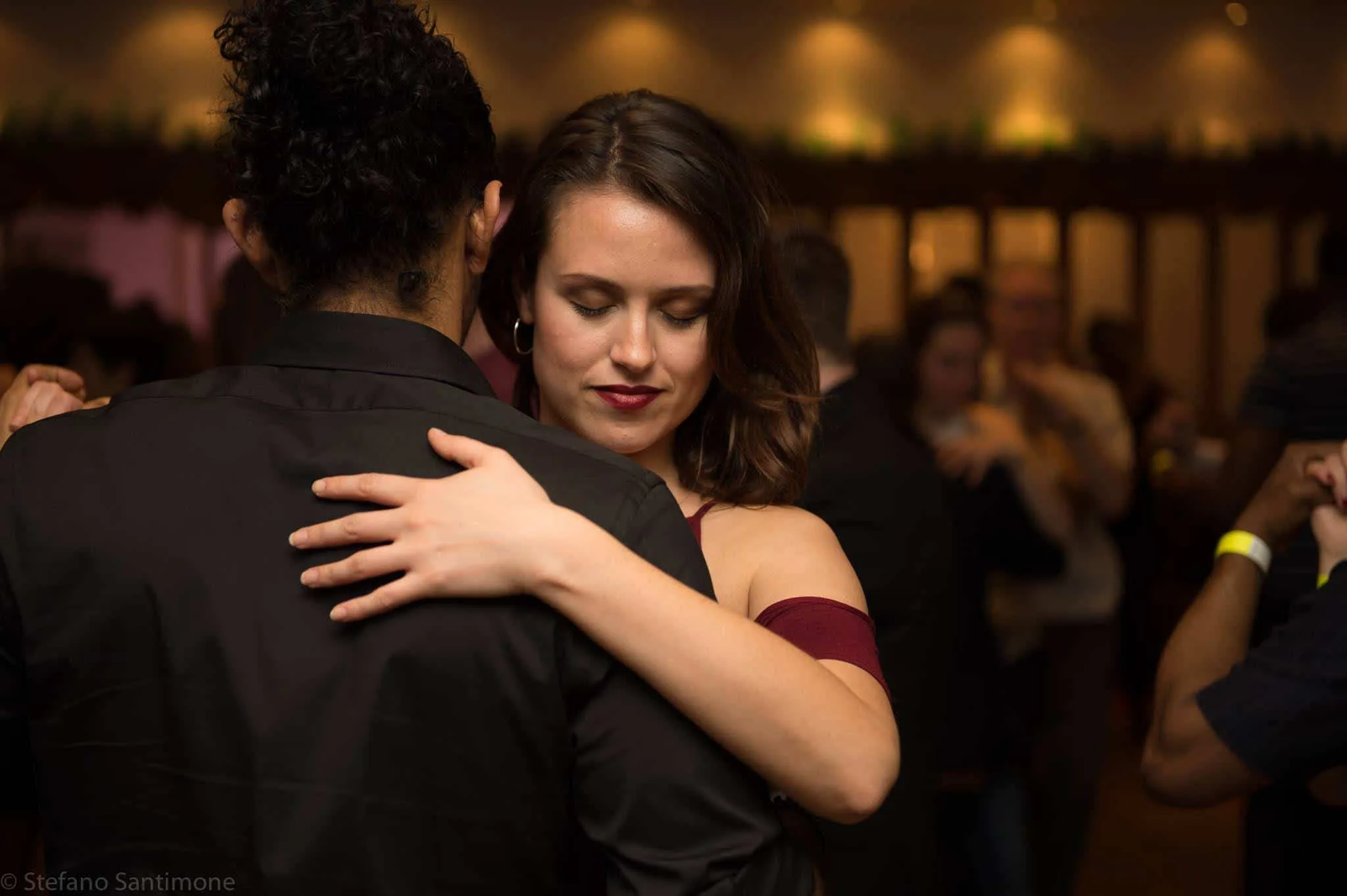 Couple dancing at Rhythm and Vibes dance social in London, intimate close-hold partner dance with soft venue lighting — salsa, bachata, kizomba venue in London