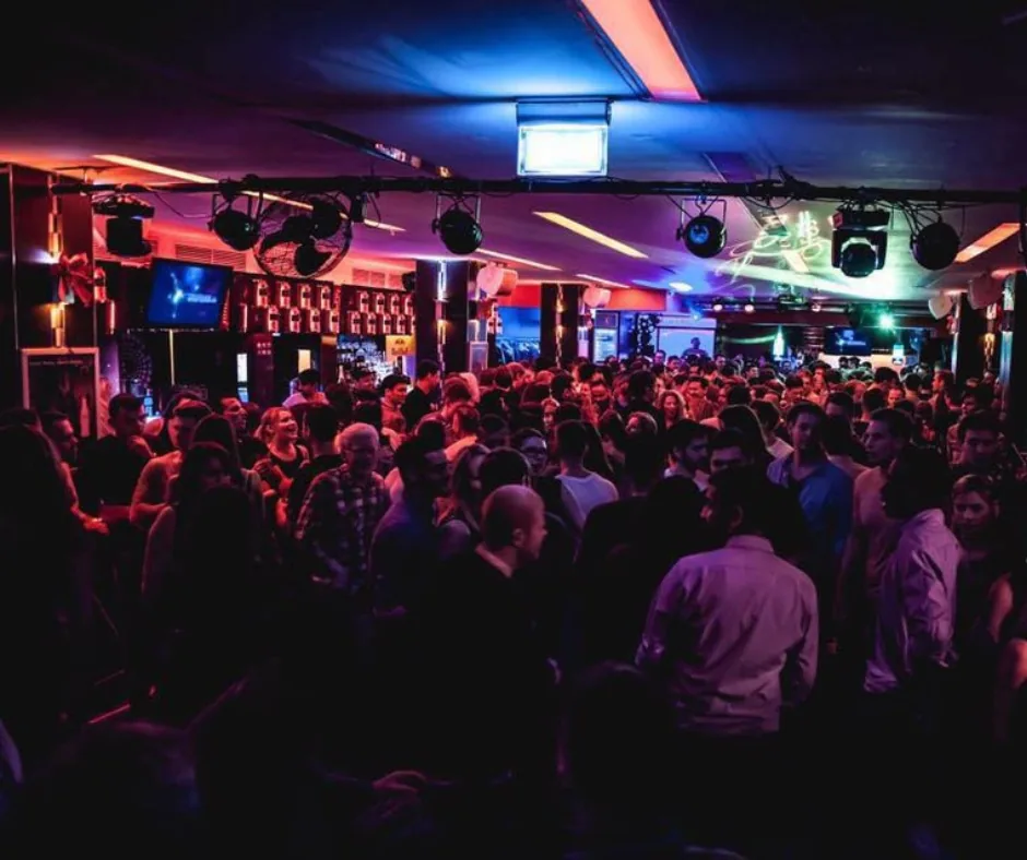 Packed dance floor and stage lighting inside 7GradX club in Stuttgart