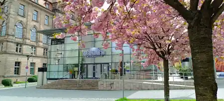 Cinecitta Nuremberg branded exterior with cherry blossom trees in spring — salsa, bachata, kizomba venue in Nuremberg