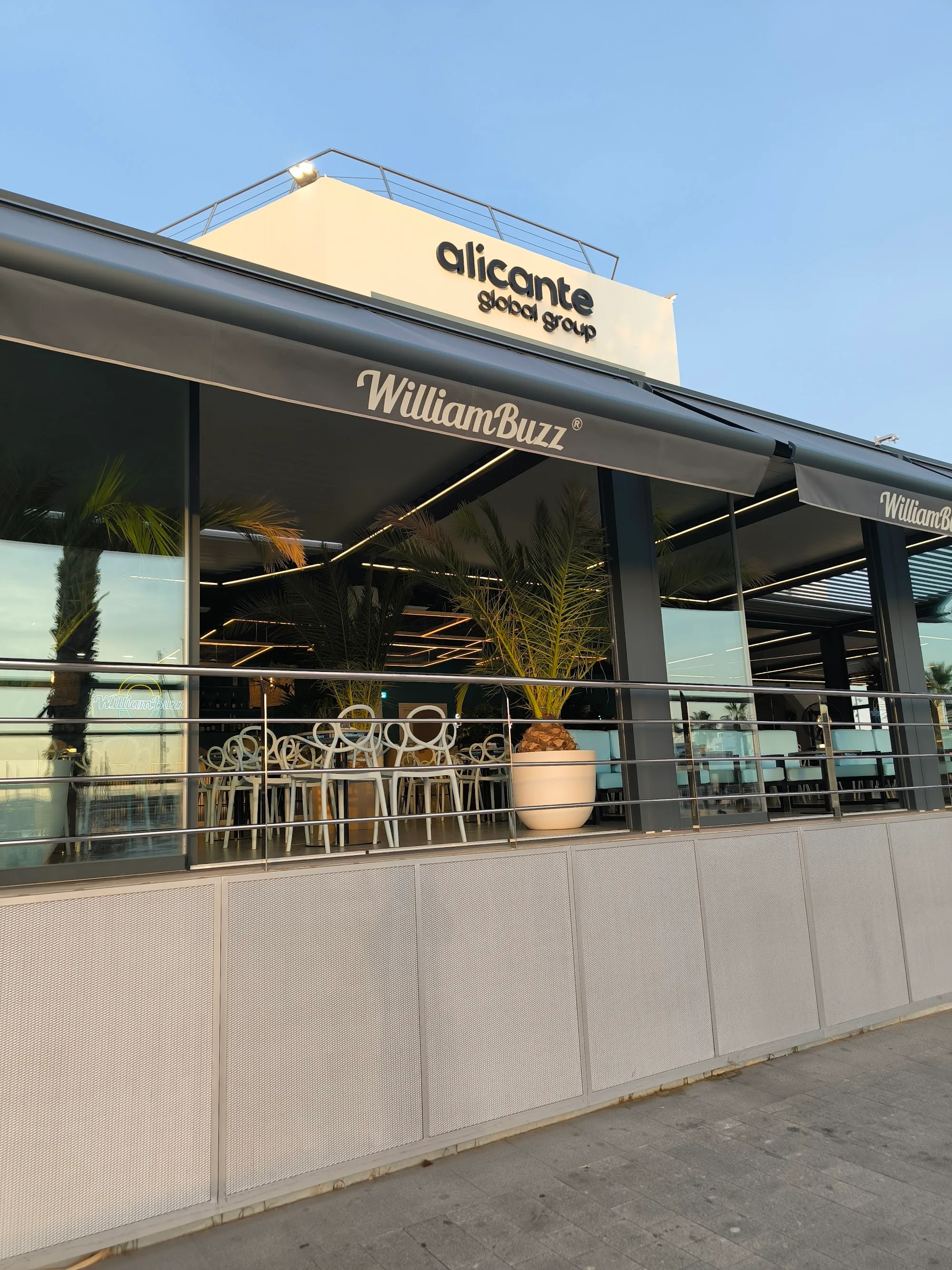 Exterior of William Buzz at Puerto de Alicante with branded signage and seafront terrace — salsa, bachata, kizomba venue in Alicante