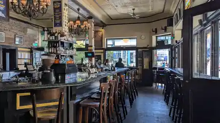Heritage bar interior with chandeliers and timber stools at Pyrmont Bridge Hotel in Sydney — bachata venue in Sydney
