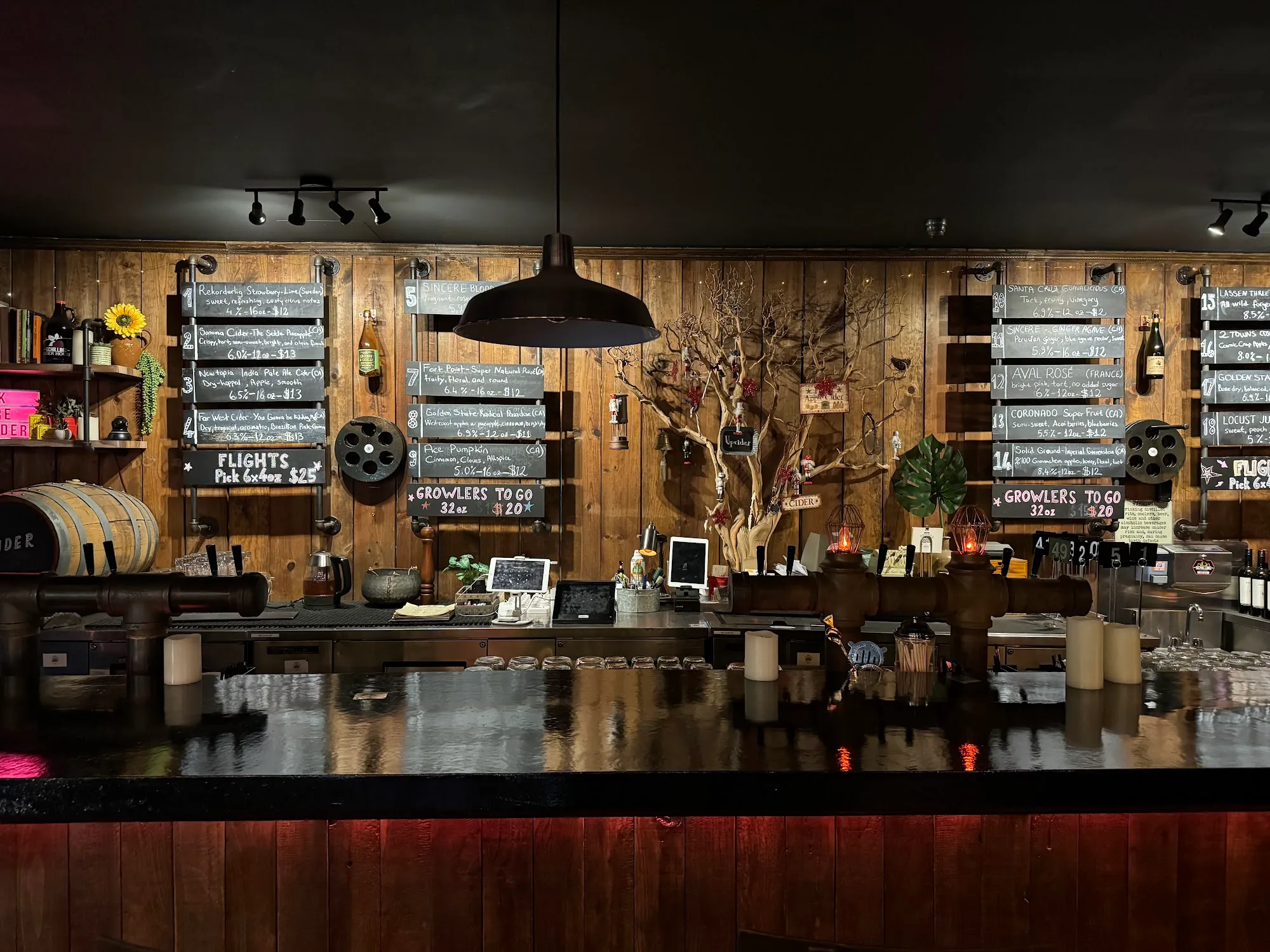 Wood-paneled back bar with chalkboard cider flight menus at Upcider gastropub in San Francisco