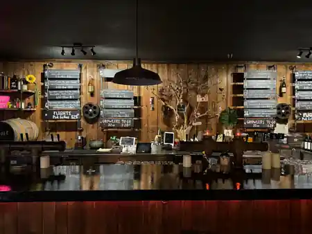 Wood-paneled back bar with chalkboard cider flight menus at Upcider gastropub in San Francisco — salsa venue in San Francisco