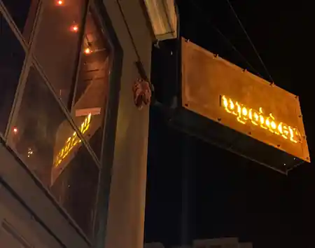 Illuminated Upcider exterior signage at night on Polk Street in San Francisco — salsa venue in San Francisco