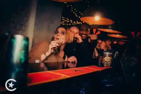 Guests enjoying drinks at Cuba Libre Latin Dance Club with warm lighting and brick wall decor in Poznan — salsa, bachata venue in Poznan