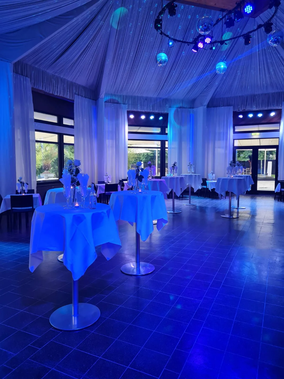 Cafe am See Nil Stuttgart event hall interior with blue lighting, disco balls, and dance floor