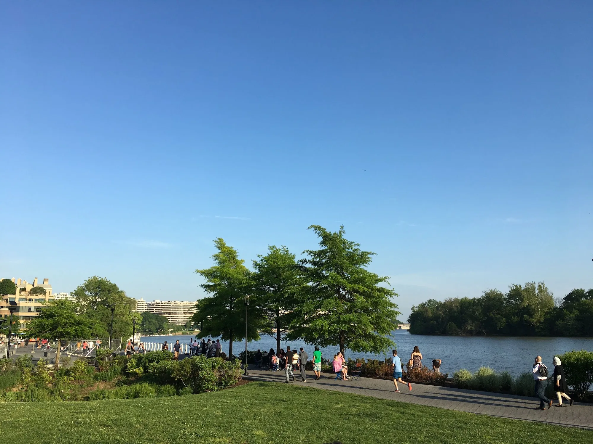 People strolling the riverside promenade at Georgetown Waterfront Park along the Potomac, Washington DC