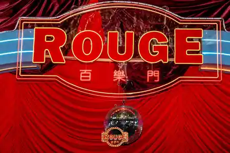 Rouge neon signage and disco ball above red velvet drape at Rouge, Darling Harbour Sydney — bachata, salsa venue in Sydney