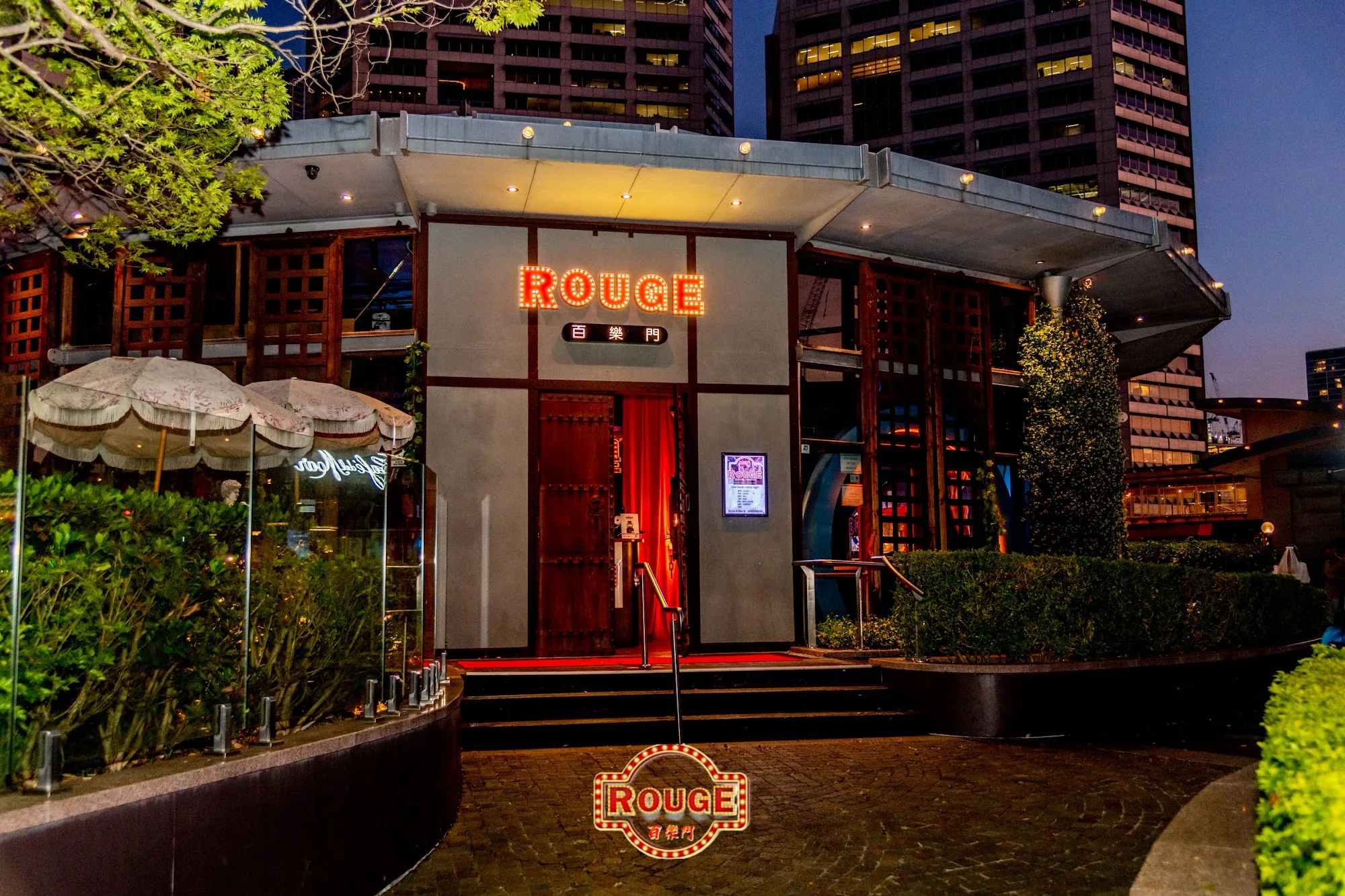 Illuminated ROUGE entrance and signage at Darling Harbour Sydney at dusk