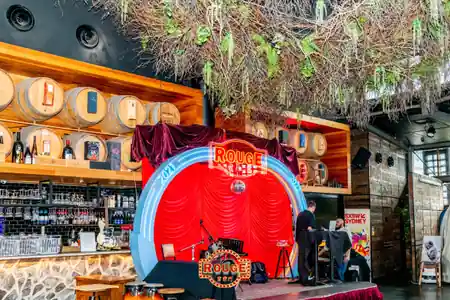 Rouge Bar interior with stage, red curtain, and bar area in Darling Harbour, Sydney — bachata, salsa venue in Sydney