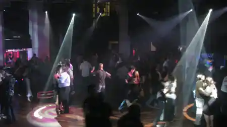 Packed social dance floor with crowd and stage lights at Gilkisons Dance Studio Perth — bachata, salsa venue in Perth