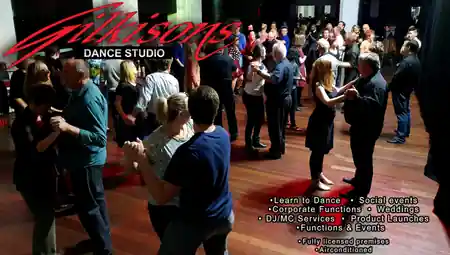 Social dance event crowd at Gilkisons Dance Studio Perth with branded signage — bachata, salsa venue in Perth