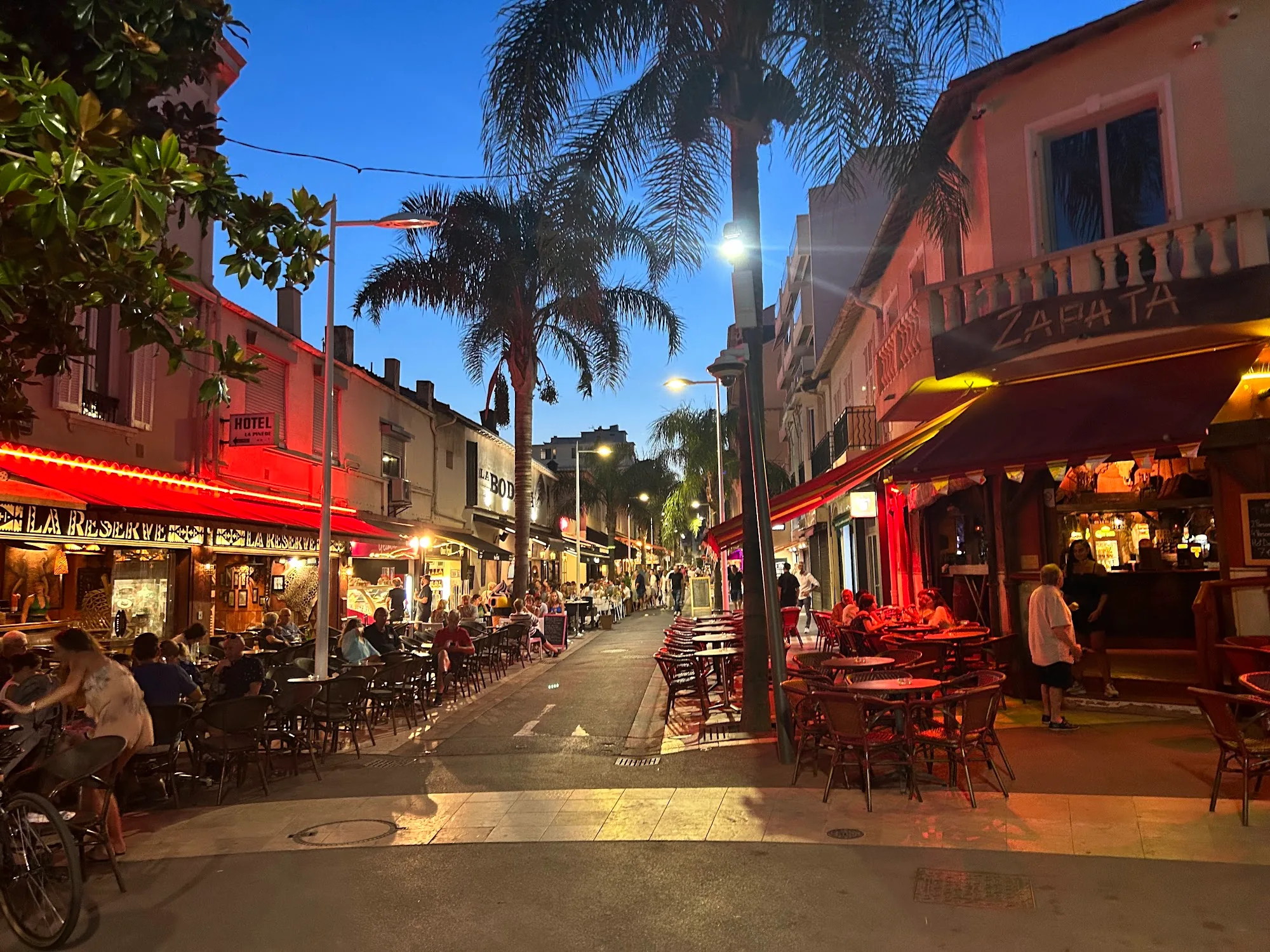 Lively outdoor dining street at night near Zapata bar Juan-les-Pins