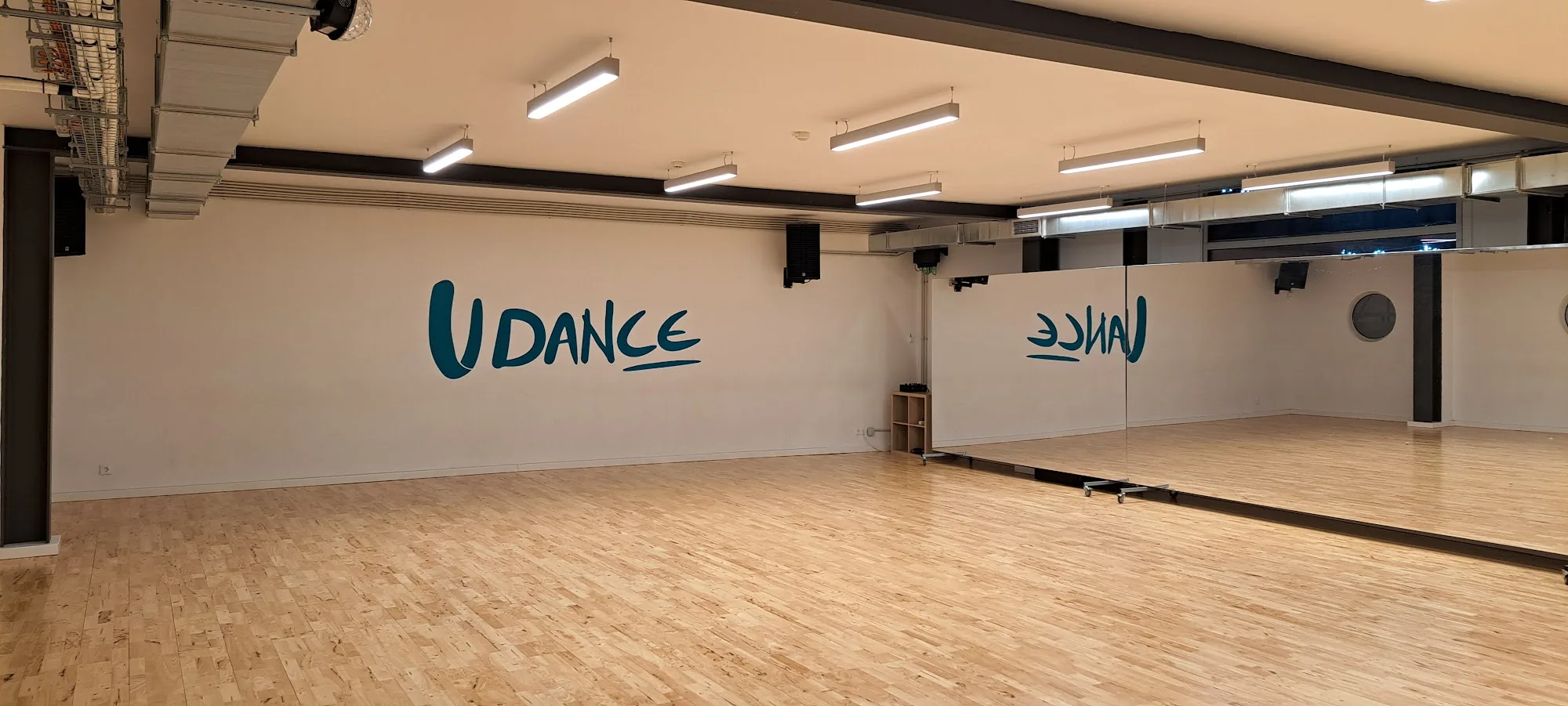 Large dance studio with branded UDANCE wall at UDance School Lisbon