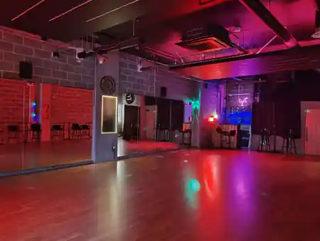 Atmospheric red and purple lit dance floor with bar at Flow Dance Studios, London, kizomba venue in London
