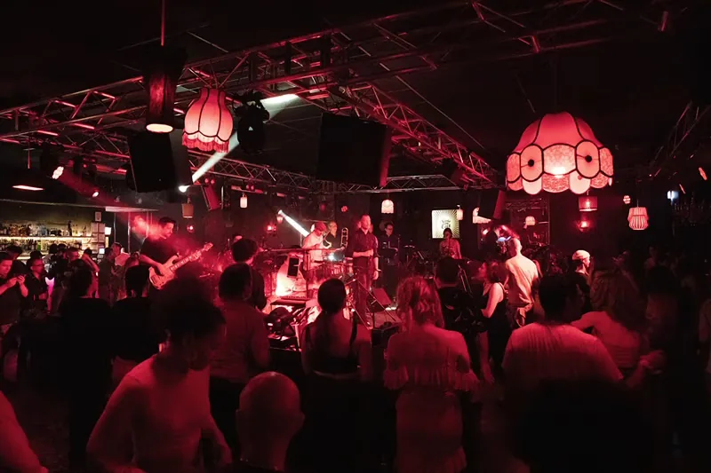 Crowd dancing under red lights with live band at The Night Cat in Melbourne