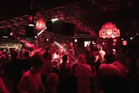 Crowd dancing under red lights with live band at The Night Cat in Melbourne — salsa, bachata venue in Melbourne